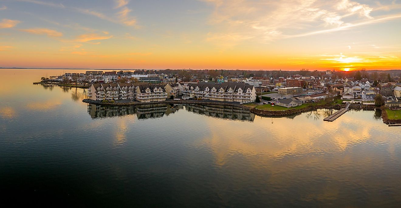 Aerial sunset panorama of Havre de Grace, Maryland, with an orange sky and clouds reflecting on the Susquehanna River and the Chesapeake Bay.