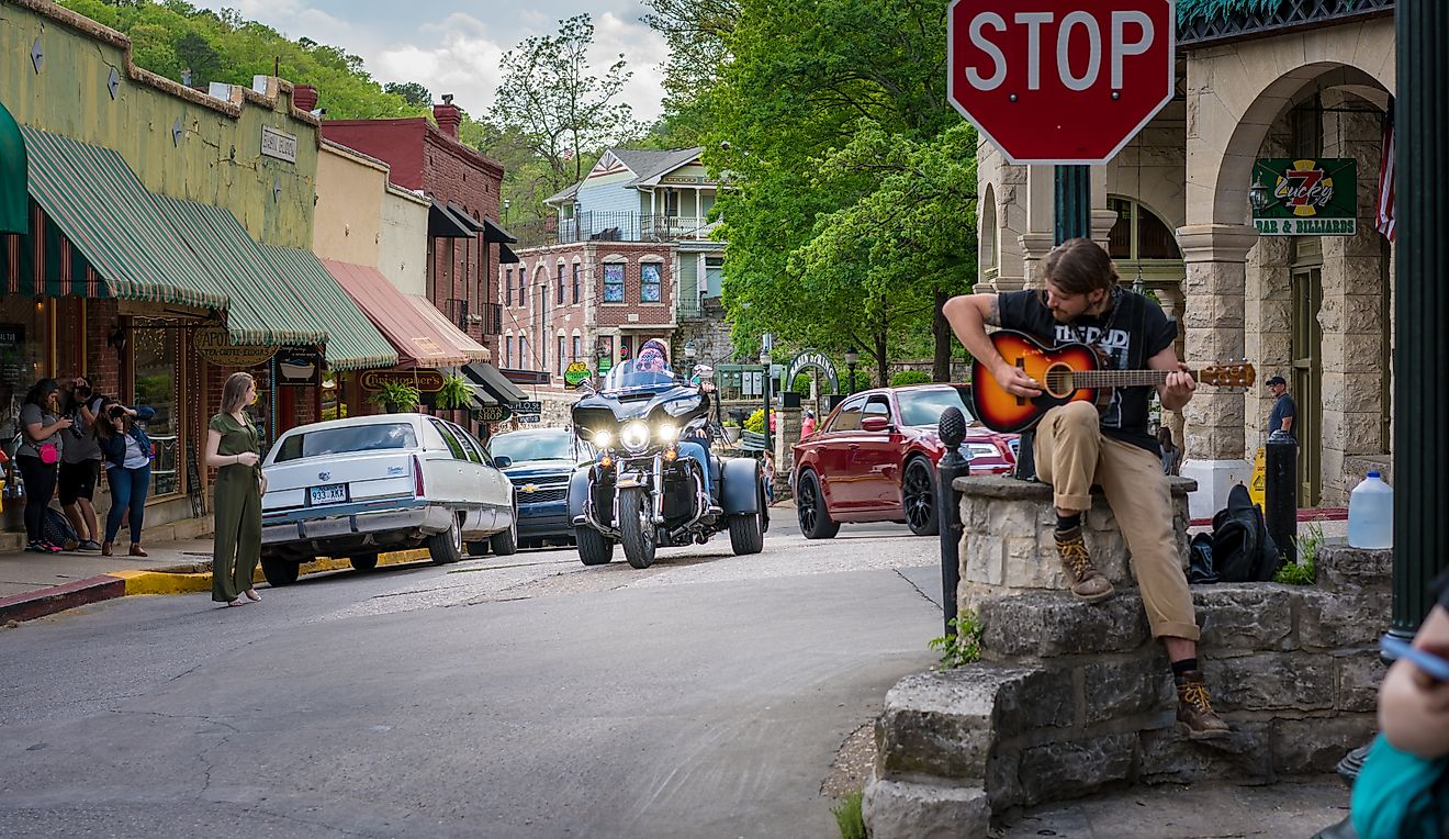 Bikers Riding Motorcycles in Downtown Eureka Springs, Arkansas, USA, Man Playing Guitar at Stop Sign. Editorial credit: shuttersv / Shutterstock.com
