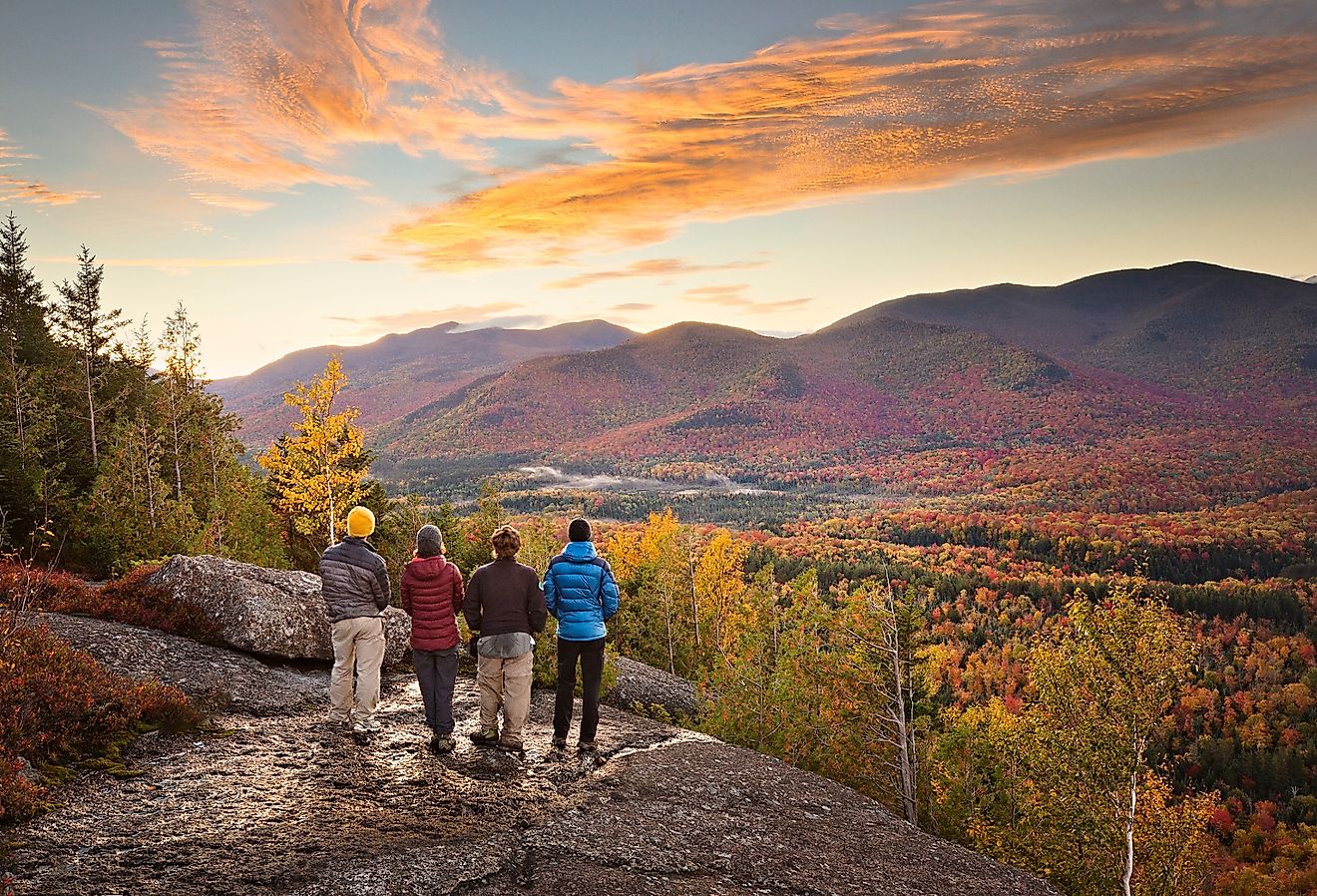 Group of hikers enjoying the view of the fall colors in the Adirondacks in New York.