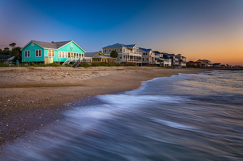 Waves in Atlantic Ocean and beachfront homes at sunrise, Edisto Beach, South Carolina