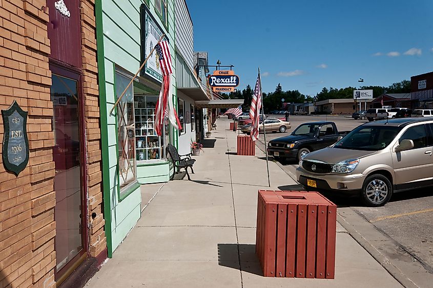 Sidewalk view of shops and cars in Garrison, North Dakota.