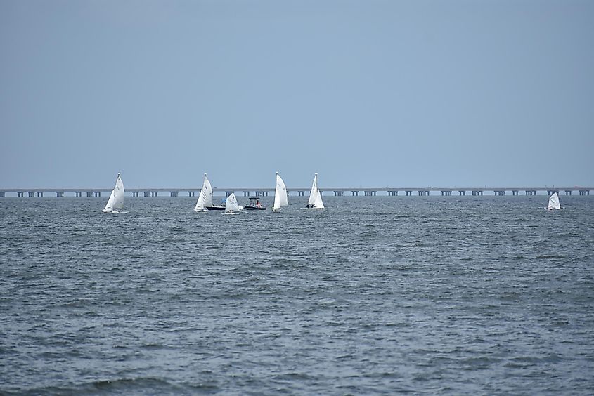 A fleet of sailboats enjoy the challenge of exploring Lake Pontchartrain on a warm, sunny day in New Orleans
