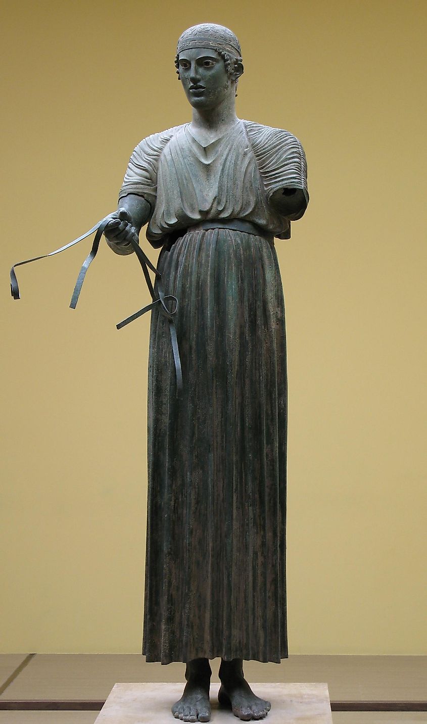 The famous Charioteer belonged to a bronze statuary complex of a chariot run by four horses and included a second male figure, via the Archaeological Museum of Delphi