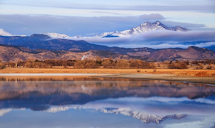 A view of the McIntosh Lake, Longmont, Colorado,  at sunrise with Meeker and Longs Peak in the background.
